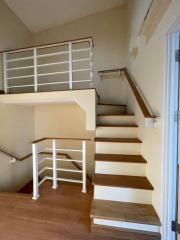 Wooden staircase with white railings inside a home