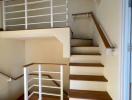 Wooden staircase with white railings inside a home