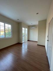 Spacious bedroom with hardwood floors and ample natural light