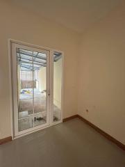 Empty bedroom with sliding door leading to outside space