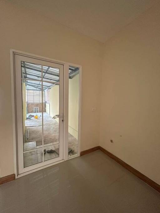 Empty bedroom with sliding door leading to outside space