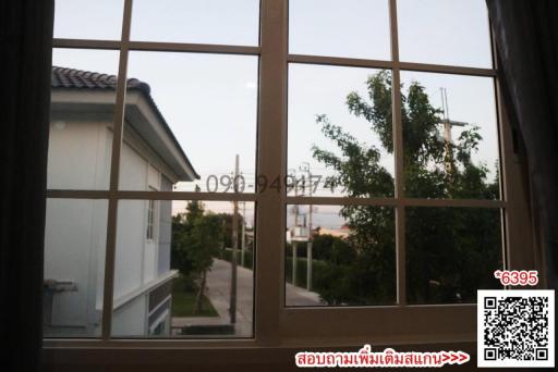 View of the exterior of a building through a window at dusk