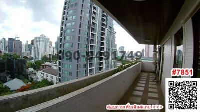 Spacious balcony with city view in a high-rise apartment building