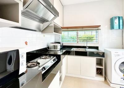 Modern kitchen with stainless steel appliances and ample sunlight