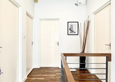 Spacious and well-lit hallway with wooden floors and modern decor
