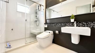 Modern bathroom with walk-in shower and wall-mounted sink