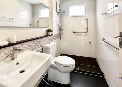 Modern bathroom with white fixtures and tiled floor