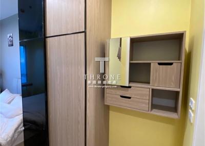 Compact bedroom with built-in wardrobe and shelving unit