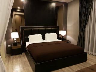 Elegant master bedroom with dark wooden furniture and neutral color palette