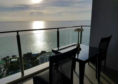 Seaside balcony with sunset view and seating area