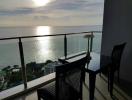 Seaside balcony with sunset view and seating area