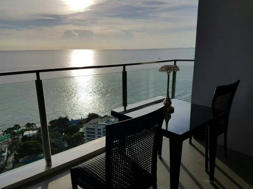 Seaside balcony with sunset view and seating area