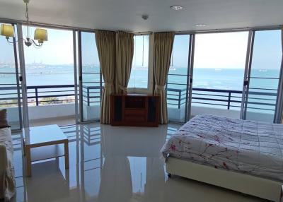 Spacious bedroom with ocean view and balcony access