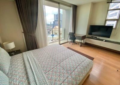 Modern bedroom with large windows and city view