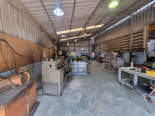 Spacious industrial workshop with various machinery and tools