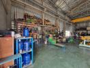 Spacious industrial warehouse interior with various machinery and equipment