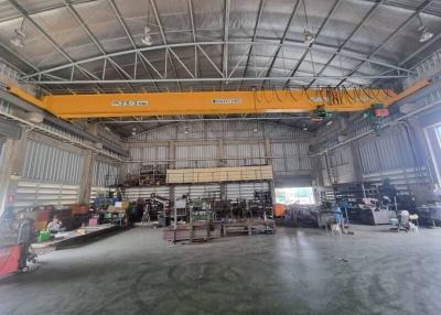 Spacious industrial warehouse interior with crane