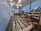 Spacious workshop with machinery and storage shelves