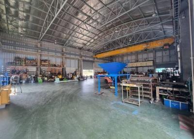 Spacious industrial building interior with high ceiling and machinery