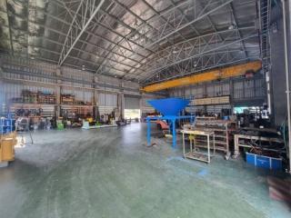 Spacious industrial building interior with high ceiling and machinery