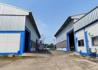 Exterior view of industrial warehouse buildings with blue and white facade
