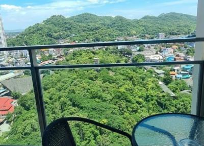 Balcony with a scenic view of the green hills and clear blue sky