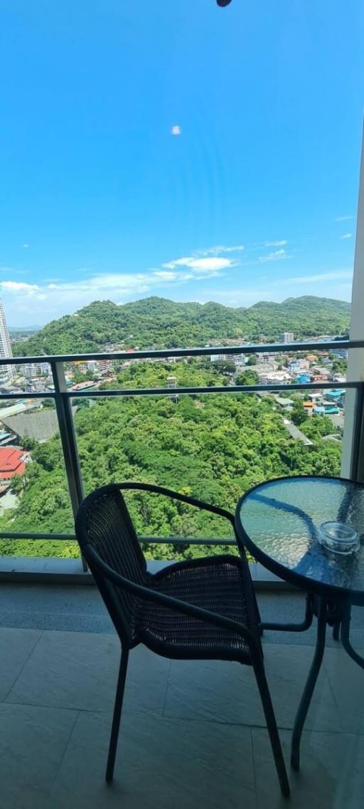 Balcony with a scenic view of the green hills and clear blue sky