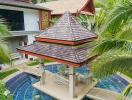 Gazebo with traditional roof in tropical outdoor setting