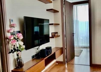 Modern living room with wall-mounted TV and floating shelves