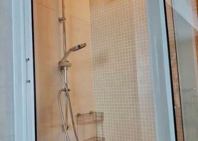 Modern bathroom with glass shower enclosure and mosaic tiles