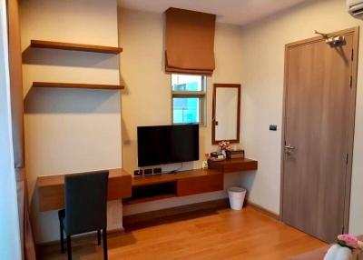 Cozy bedroom with work desk and wooden shelving