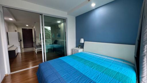 Cozy bedroom with blue bedding and accent wall