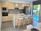 Modern kitchen with central island and pool view