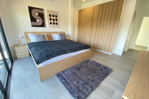 Modern bedroom interior with wooden accents and contemporary artwork