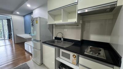 Modern kitchen with stainless steel appliances and wooden flooring