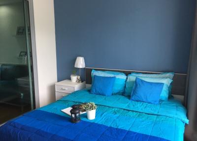 Cozy bedroom with blue bedding and modern decor