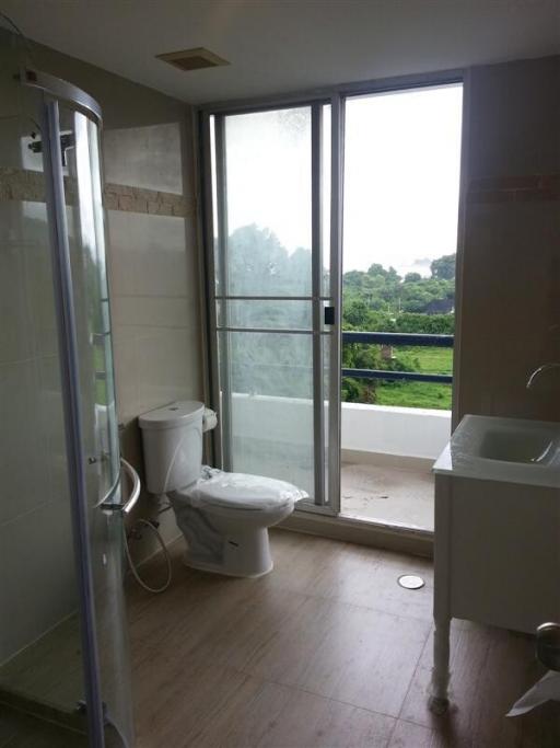 Modern bathroom with glass shower enclosure and balcony access