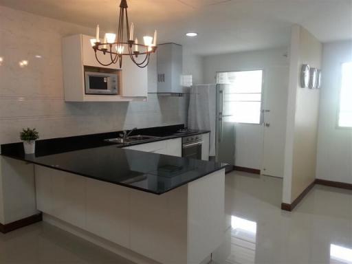 Modern kitchen with stainless steel appliances and dark countertops