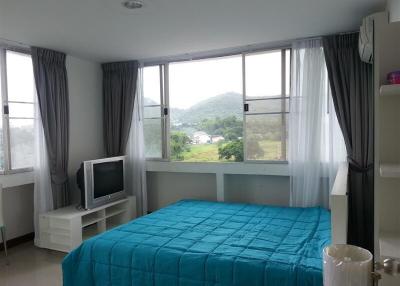 Bright bedroom with large window and mountain view