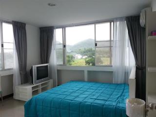 Bright bedroom with large window and mountain view