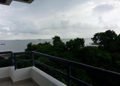 Balcony with scenic ocean view and surrounding greenery