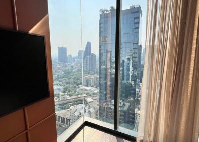 Modern bedroom with floor-to-ceiling windows and city view