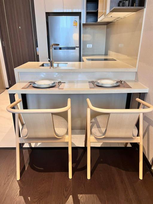 Modern kitchen with a breakfast bar and two chairs