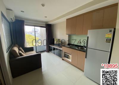 Modern kitchen with stainless steel appliances and adjacent living space