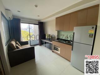 Modern kitchen with stainless steel appliances and adjacent living space