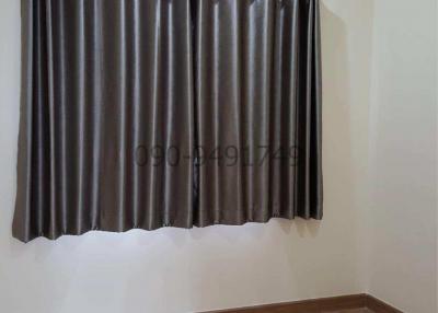 Cozy bedroom with modern flooring and elegant dark curtains