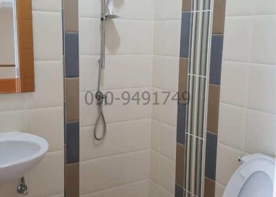 Modern tiled bathroom with shower and toilet