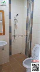 Modern tiled bathroom with shower and toilet