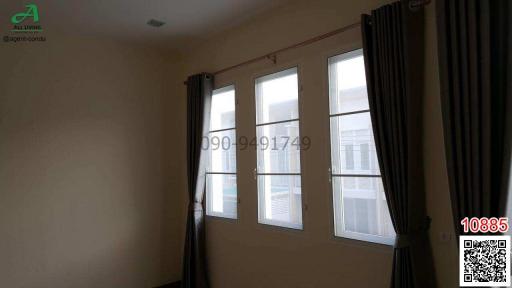 Cozy bedroom with natural light from multiple windows