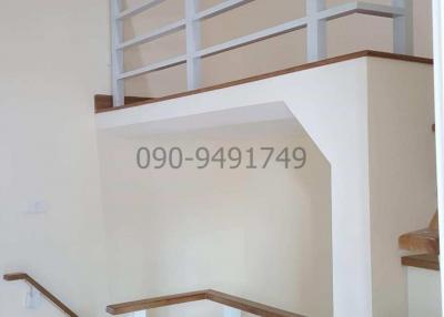 White wooden staircase with handrails in a modern home